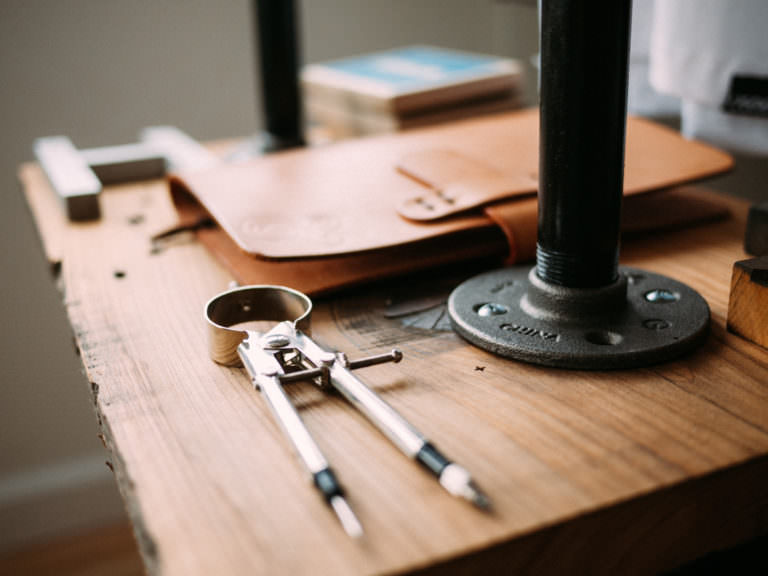 A work bench with tools used for eyeglass repairs.