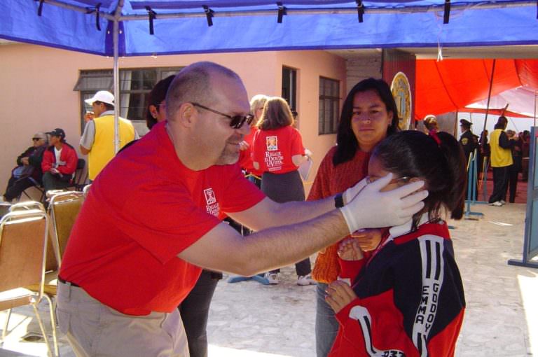 Klein Optical optician Daniel Klein fits a child with donated glasses during a mission in Mexico.