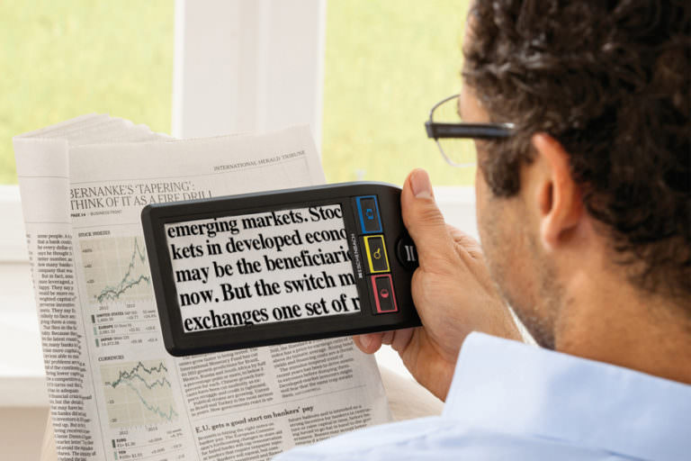 Man reading newspaper using SmartLux Digital.