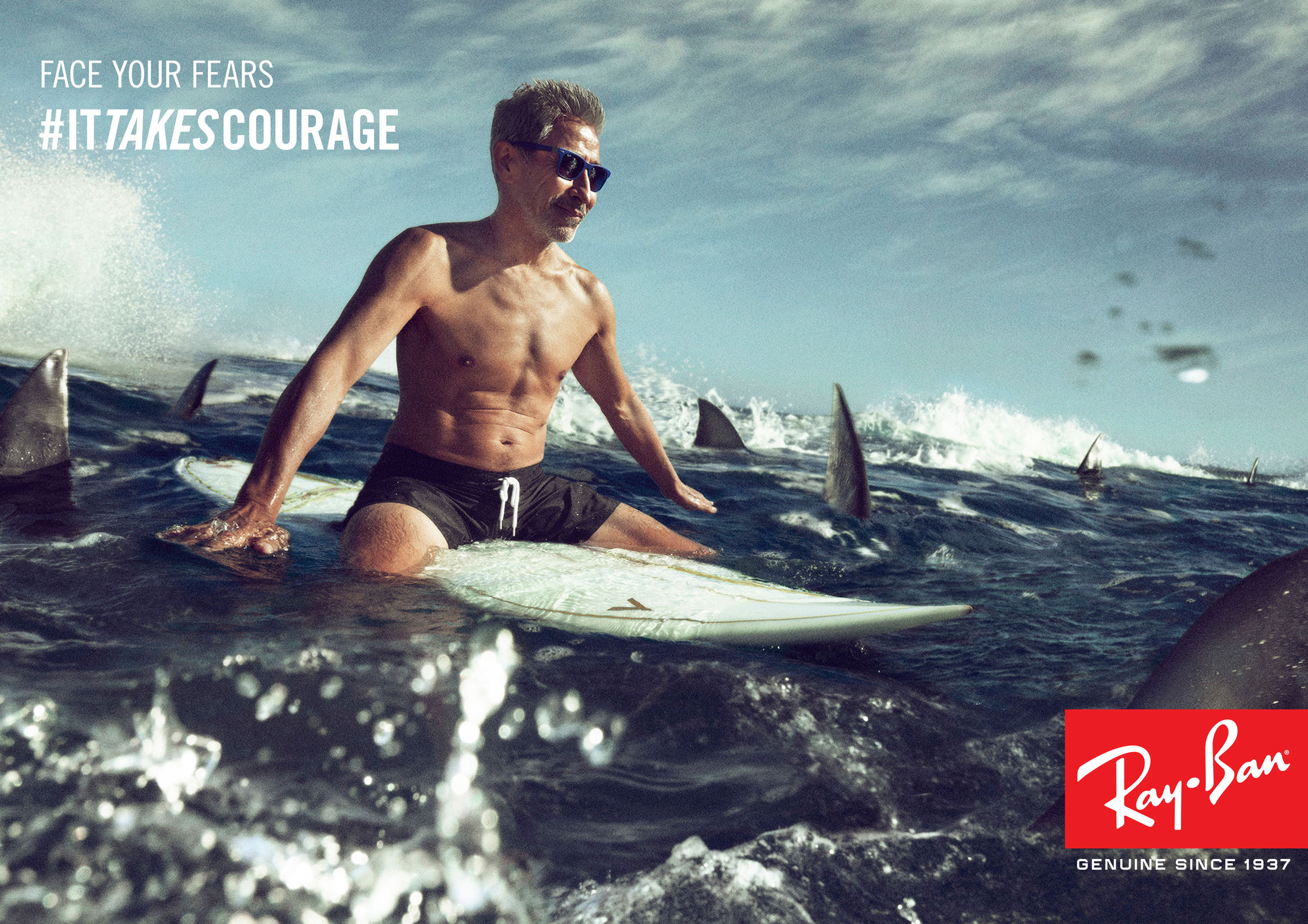 Man surrounded by sharks, surfing wearing Ray-Ban Wayfarer Liteforce plastic sunglasses with Green G-15 lenses.