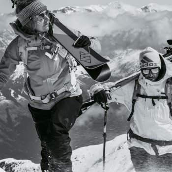 Woman and man climbing mountain wearing adidas Sport Eyewear Wildcharge and 3Matic sunglasses.