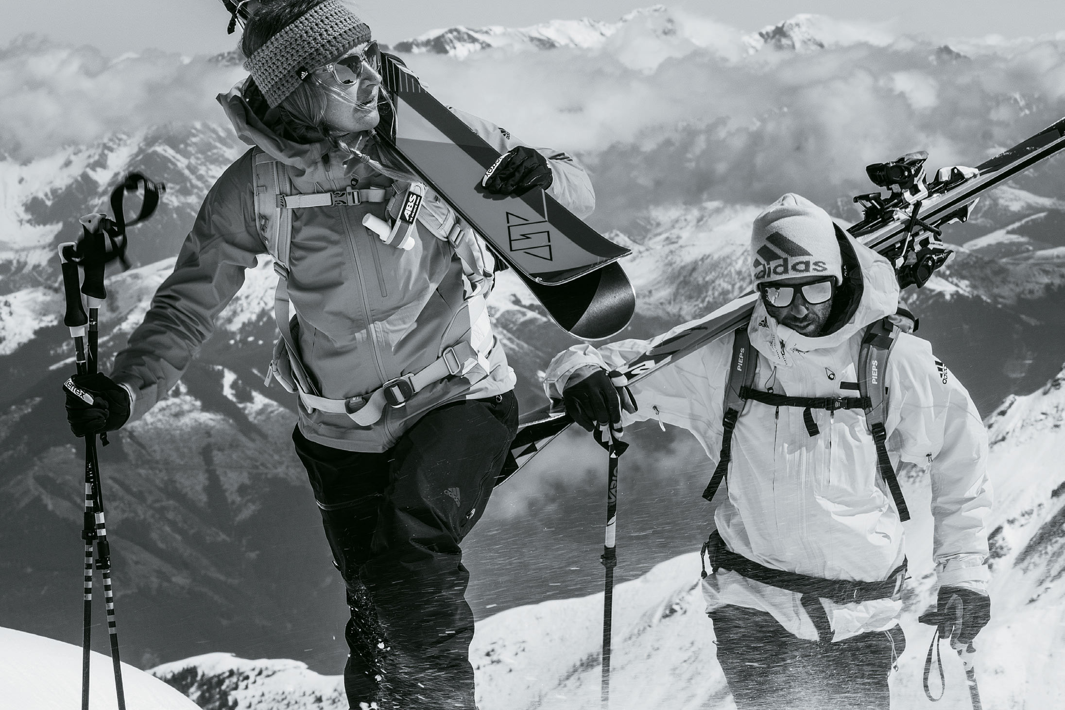 Woman and man climbing mountain wearing adidas Sport Eyewear Wildcharge and 3Matic sunglasses.